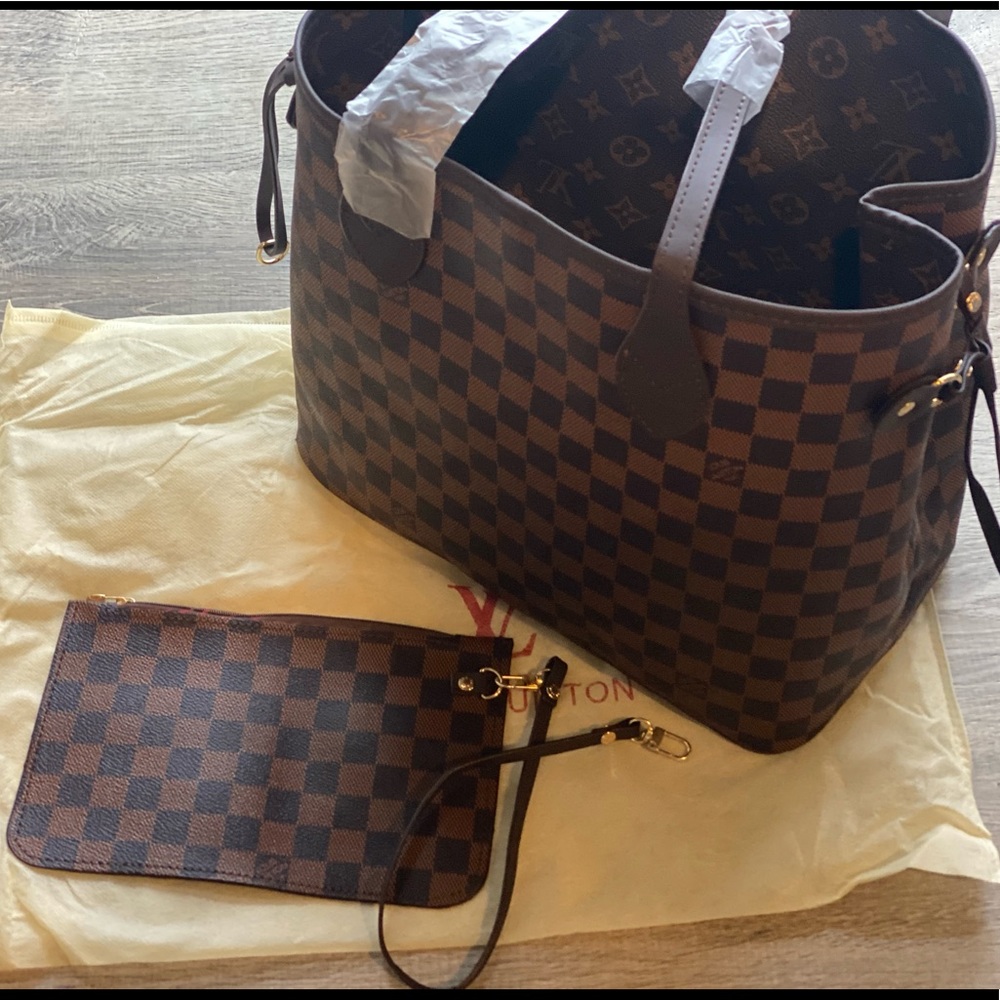 Faux leather Designer style bag with wristlet and dust cover.